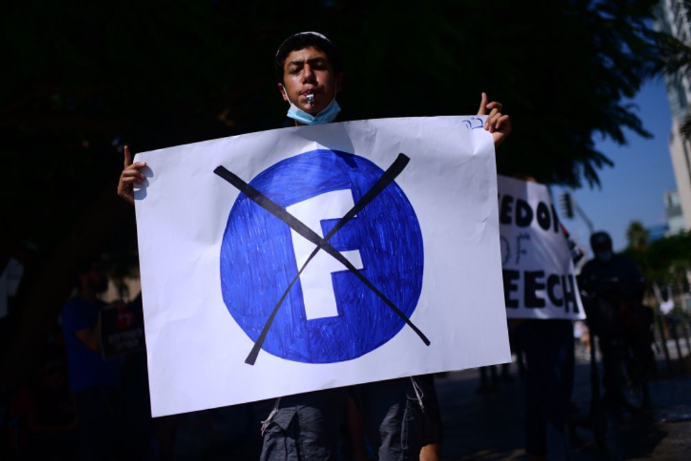Protestors demonstrate outside the Facebook company branch in Tel Aviv, Israel, on July 15, 2021.