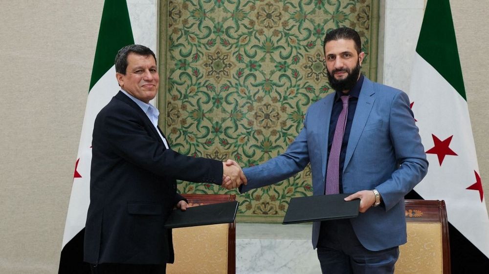 Picture showing Syrian interim president Ahmed al-Sharaa shaking hands with Syrian Defense Forces commander Mazloum Abdi