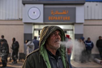 A Palestinian worker waits at the last station in Beit Hanun of the northern Gaza Strip, before reaching Israel through the Erez crossing to work, on February 23, 2022.