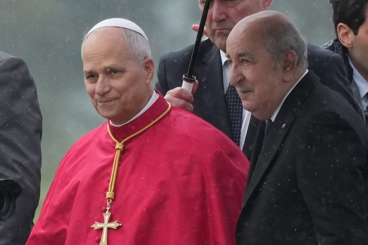 Pope Leo XIV is welcomed by Algerian President Abdelmadjid Tebboune, right, upon his arrival at Algiers' Houari Boumédiène International Airport on Monday, April 13, 2026, at the start of an 11-day apostolic journey to Africa
