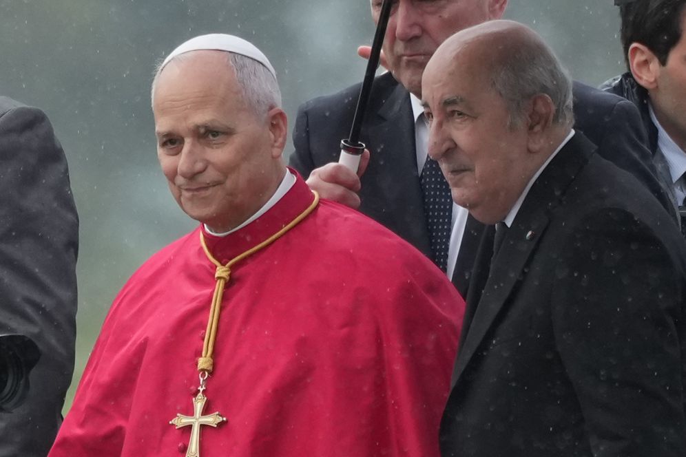 Pope Leo XIV is welcomed by Algerian President Abdelmadjid Tebboune, right, upon his arrival at Algiers' Houari Boumédiène International Airport on Monday, April 13, 2026, at the start of an 11-day apostolic journey to Africa
