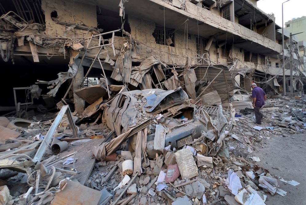 A man checks his destroyed shop at a street that was hit in an Israeli airstrike in Dahiyeh, in the southern suburb of Beirut, Lebanon, Thursday, Nov. 14, 2024.
