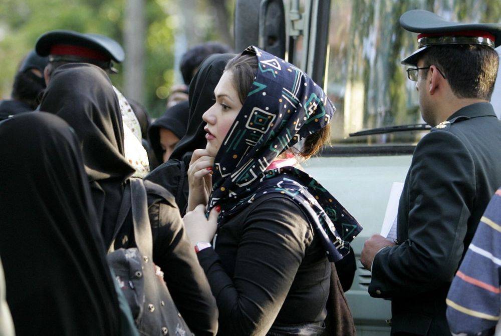 Vice police warn young women against wearing the veil deemed illegal in Tehran, Iran