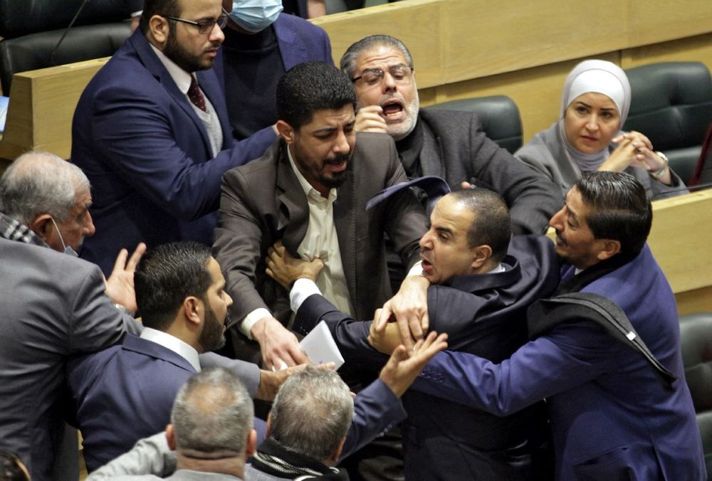 Parliament members are separated during an altercation in the parliament in the capital Amman, Jordan, on December 28, 2021.