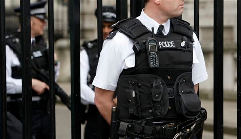 Police officers guard Downing Street in London following anti-terror swoops by police in Greater Manchester and Liverpool, England, April 10, 2009.