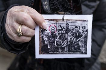 Holocaust survivor and former prisoner of the Nazi death camp Auschwitz-Birkenau, Miriam Ziegler (Friedman), shows a historical picture of her and other prisoners in Oswiecim on January 26, 2020.