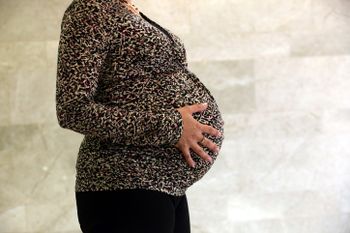 A pregnant woman.