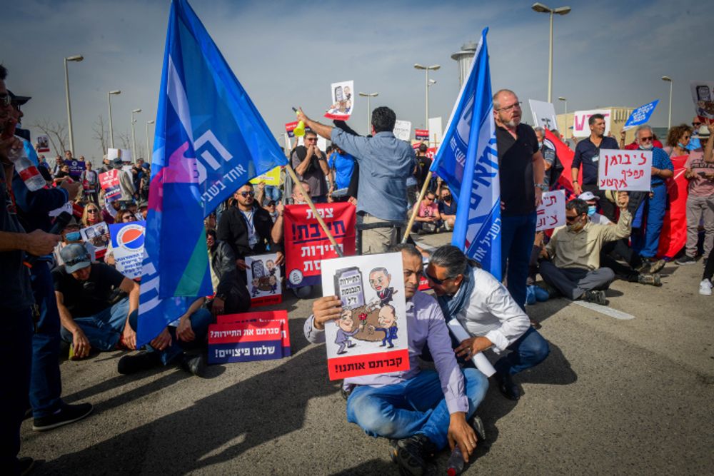Workers from the tourism sector protest outside Ben Gurion International Airport in Israel on December 13, 2021.