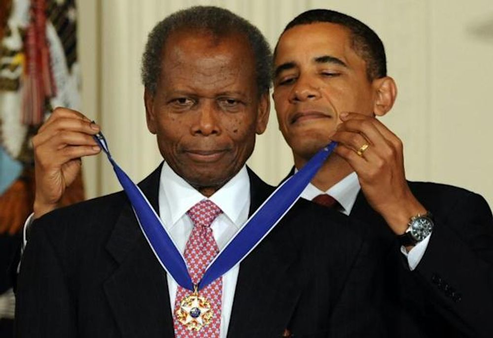 Then-US president Barack Obama presents the Presidential Medal of Freedom to Sidney Poitier in 2009 at the White House in Washington, DC.
