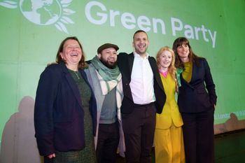 Green Party candidate Hannah Spencer, second right, celebrates with party leader Zack Polanski, center, and supporters at a volunteer thank you event after winning the Gorton and Denton by-election, Manchester, England, Friday, Feb. 27, 2026.