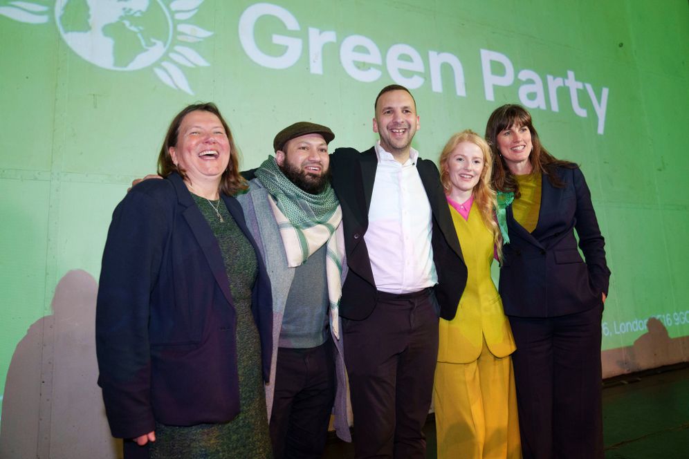 Green Party candidate Hannah Spencer, second right, celebrates with party leader Zack Polanski, center, and supporters at a volunteer thank you event after winning the Gorton and Denton by-election, Manchester, England, Friday, Feb. 27, 2026.