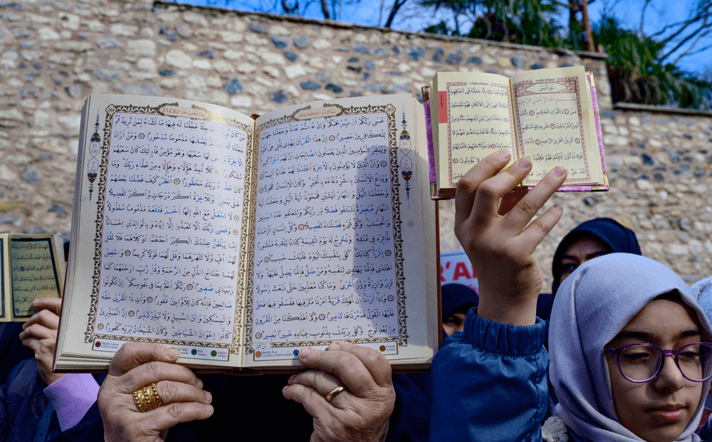 Protesters hold copies of the Quran outside the Swedish Consulate General in Istanbul, Turkey, on January 22, 2023.