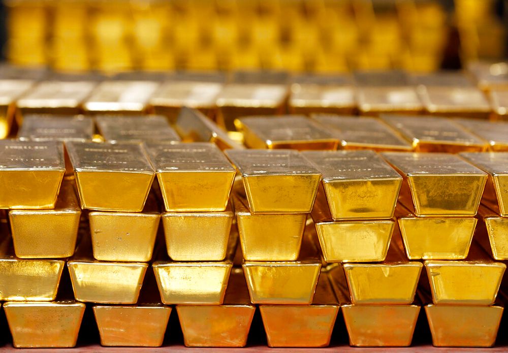 FILE - In this July 22, 2014, file photo, gold bars are stacked in a vault at the United States Mint, in West Point, United States.