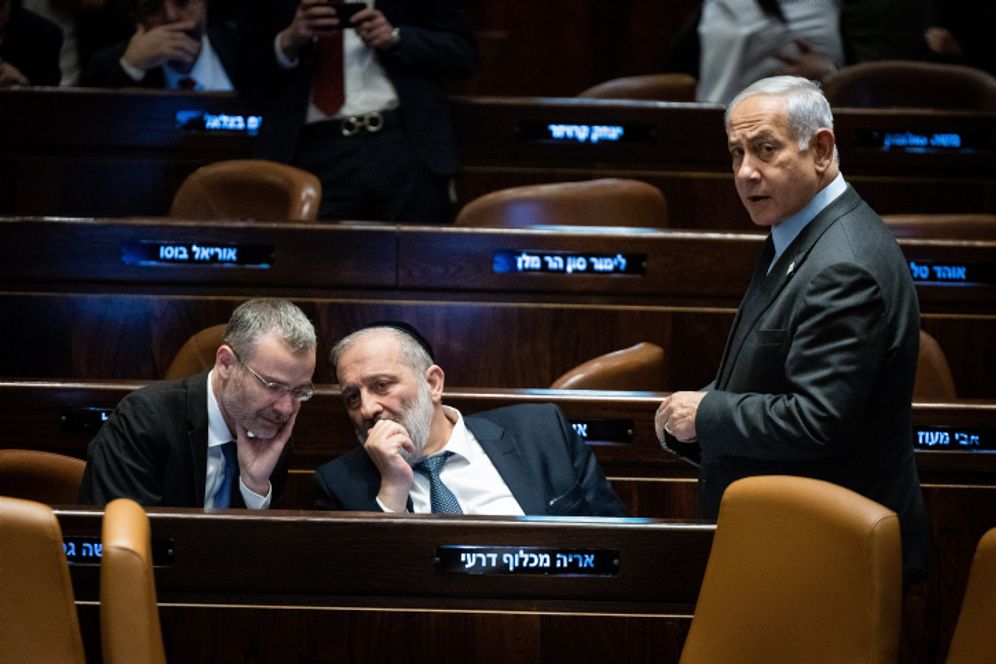 Israeli Prime Minister Benjamin Netanyahu (R) with Justice Minister Yariv Levin (L) and MK Aryeh Deri at the Israeli parliament in Jerusalem.
