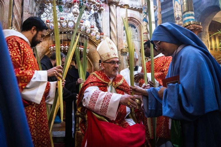 Latin Patriarch of Jerusalem Pierbattista Pizaballa leads the procession on Palm Sunday, in the Church of the Holy Sepulchre, in Jerusalem's Old City on April 10, 2022.