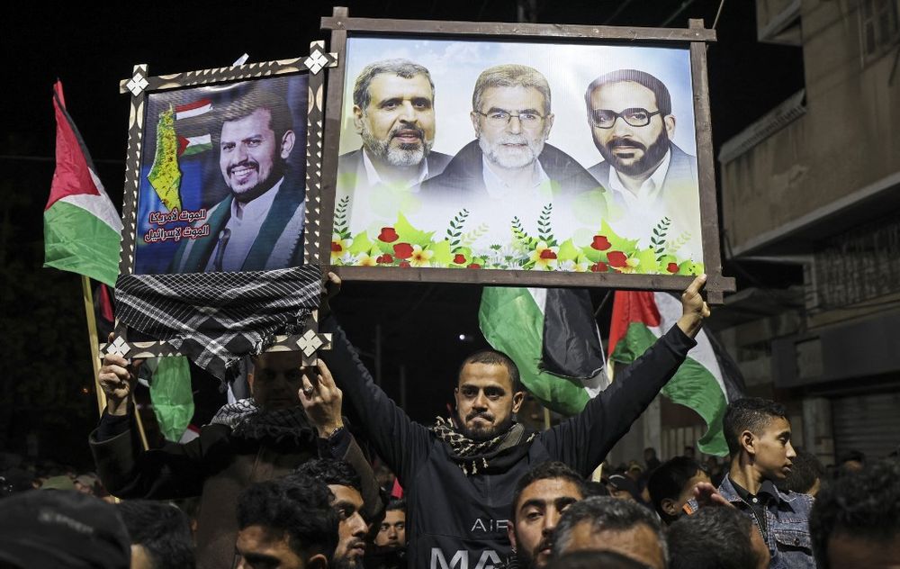 Des partisans du Jihad islamique palestinien brandissent des pancartes des responsables de leur faction et du chef rebelle houthi Abdul-Malik al-Houthi (à gauche) lors d'une manifestation à Gaza le 22 janvier 2022.