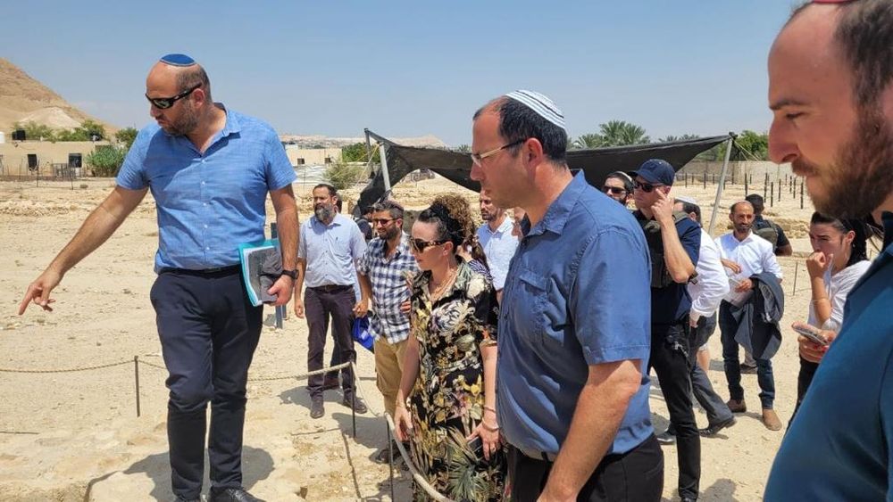 Israel's Environmental Protection Minister Idit Stilman (C-L), Religious Zionist lawmaker Simcha Rothman (C-R), and a group participating in the Knesset Land of Israel Caucus tour of Tel Yericho.