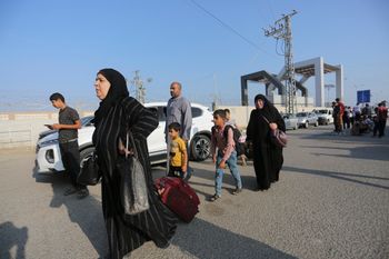 Palestinians wait at the border crossing between the Gaza Strip and Egypt, in Rafah, Wednesday, Nov. 1, 2023.