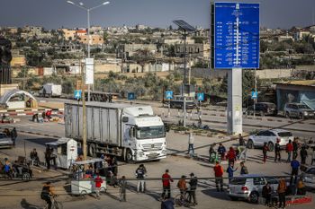 Trucks with aid arrive at the Palestinian side of the Kerem Shalom border crossing in the southern Gaza Strip on January 17, 2024.