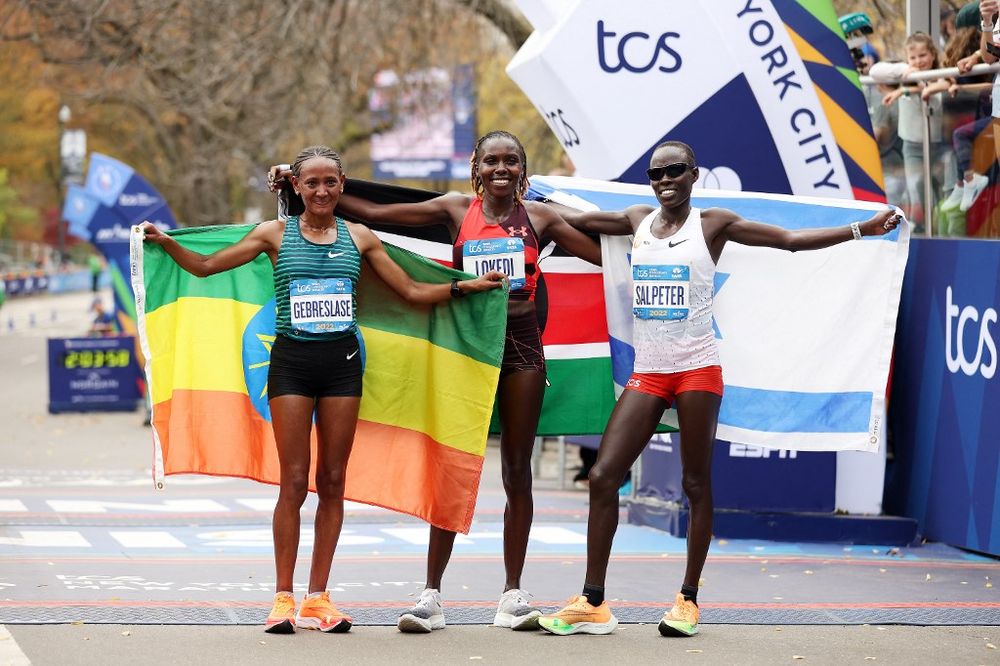 Second place finisher Lonah Chemtai Salpeter of Israel, Sharon Lokedi of Kenya and third place Gotytom Gebreslase of Ethiopia after the women's race of the New York City Marathon on November 6, 2022 in New York City, United States.