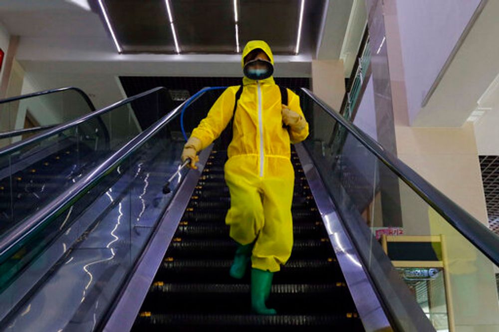 An employee of the Pyongyang Children's Department Store conducts anti-epidemic work before opening in Pyongyang, North Korea, on March 18, 2022.