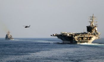 ARCHIVES — The aircraft carrier USS Dwight D. Eisenhower and other warships transit the Strait of Hormuz towards the Persian Gulf, Sunday, November 26, 2023