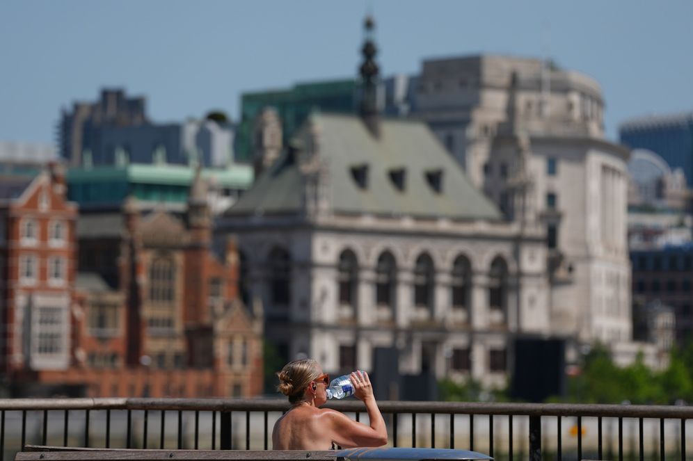 AP Photo/Kirsty Wigglesworth A woman takes a drink in London, as a heatwave is predicted Tuesday, June 23, 2026