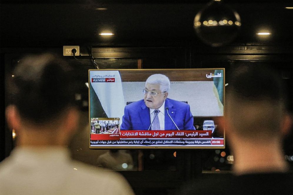 Palestinians in Hebron watch a televised speech by Palestinian Authority President Mahmoud Abbas on April 29, 2021.