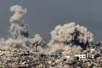 A picture taken from southern Israel near the border with the Gaza Strip on December 8, 2023, shows smoke rising above buildings during an Israeli strike in northern Gaza, amid continuing battles between Israel and the militant group Hamas.