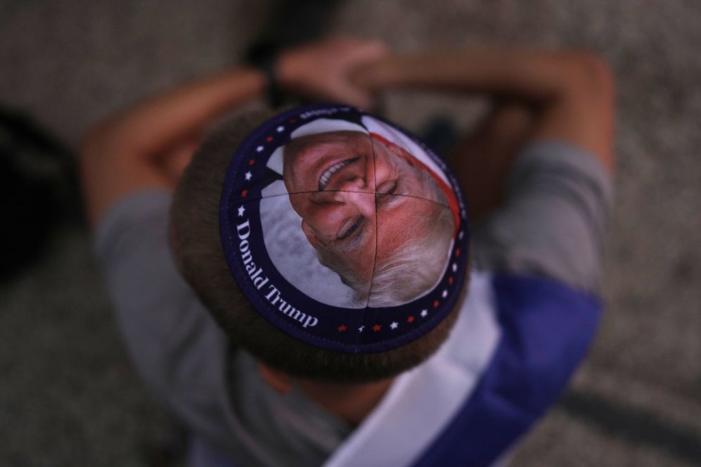 A Jewish man wears a kippah printed with the image of U.S. President Donald Trump 