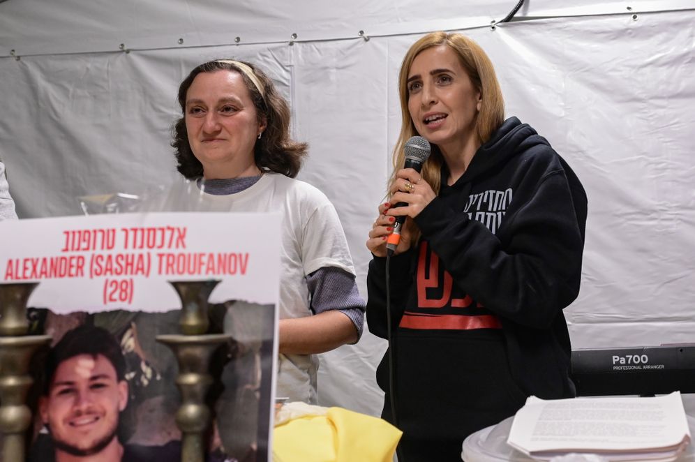 Lena Trufanov, mother of hostage Sasha Trufanov, and freed hostage Danielle Aloni take part in a ceremony for the release of Israelis held hostage at Hostage Square in Tel Aviv