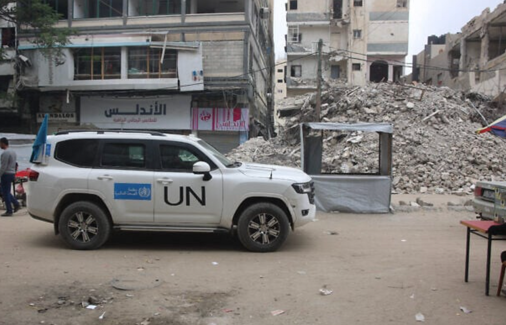 A United Nations vehicle is parked next to the rubble of a destroyed building in Gaza City, May 12, 2025.