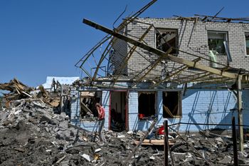 Oleksandr, 47, talks on his mobile phone next to his parents house, destroyed by an earlier Russian missile attack, in the town of Kramatorsk, Donetsk Region, Ukraine.