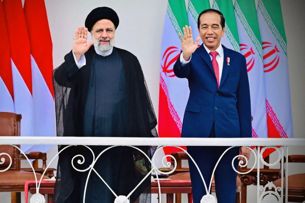 Indonesian President Joko Widodo (R) and his Iranian counterpart Ebrahim Raisi gesturing to photographers at the Presidential Palace in Bogor, Indonesia.