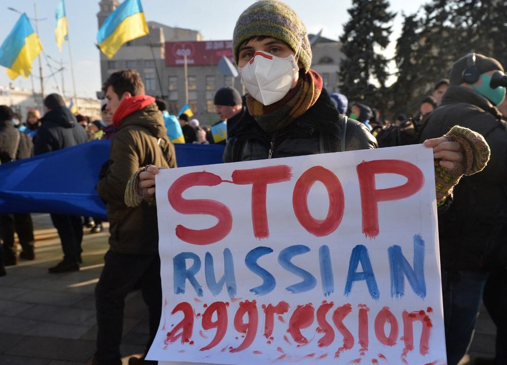 A protester holds a placard during a Unity March amid soaring tensions with Russia, in Kharkiv, eastern Ukraine, on February 5, 2022.