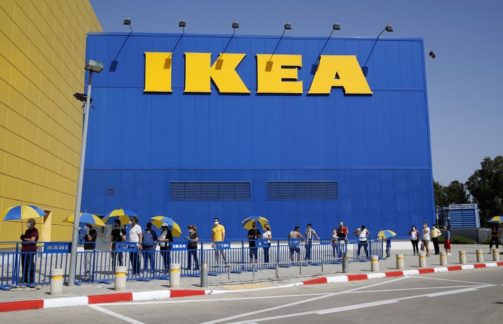 Customers maintain a safe distance from each other as they wait in line to enter an IKEA outlet in the Israeli coastal town of Netanya on April 22, 2020