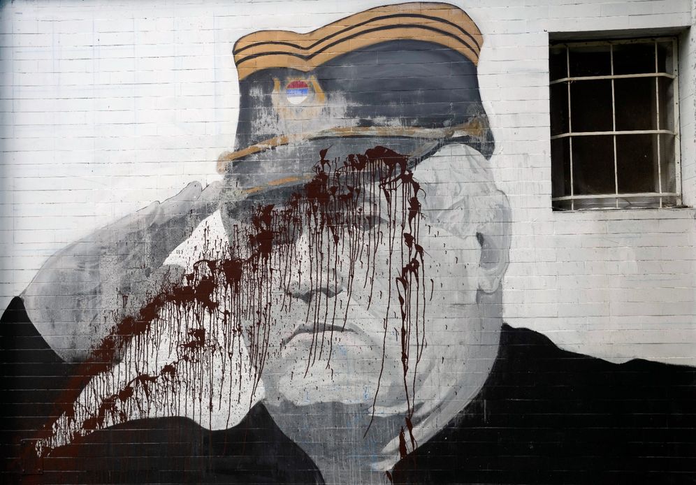 (AP Photo/Darko Vojinovic, File) FILE - A mural of former Bosnian Serb military chief Ratko Mladic vandalized with paint in Belgrade, Serbia, Tuesday, Sept. 20, 2022.