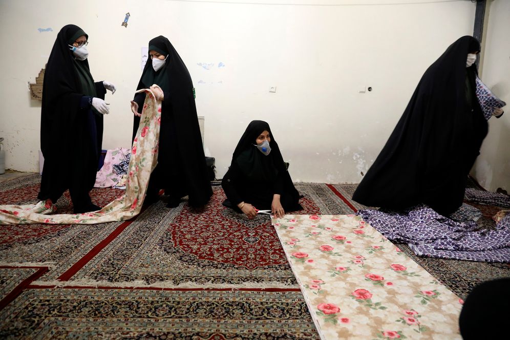 AP Photo/Vahid Salemi Volunteer women prepare fabric to sew bed sheets for hospitals in a mosque in southern Tehran, Iran, April 5, 2020.
