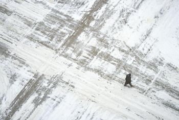A man crosses a snow covered square in Minneapolis, Minnesota, US.