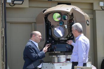 Israel's Prime Minister Naftali Bennett, (L), gets an update on Rafael's under-development Magen Or laser defense system, Haifa, June 1, 2022.