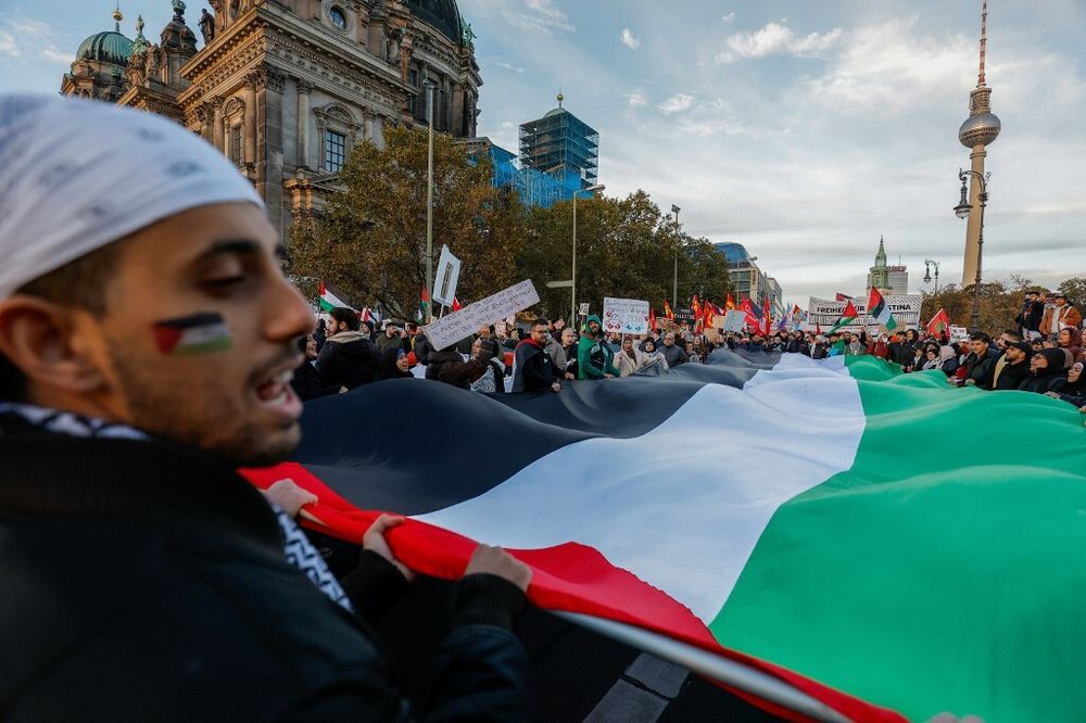 Demonstrators carry a giant Palestinian flag during a protest in support of Palestinians under the slogan 'Free Palestine' in Berlin, Germany.