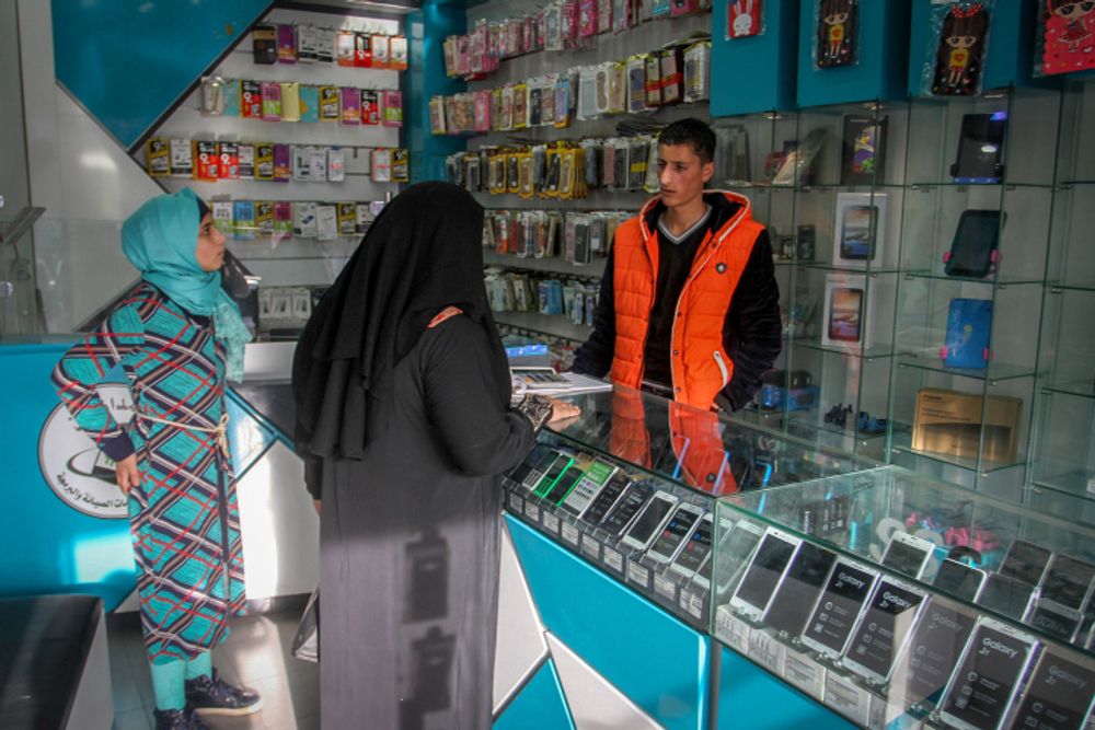 A Palestinian man works in a mobile phone shop in Rafah in the southern Gaza Strip, on November 20, 2016.