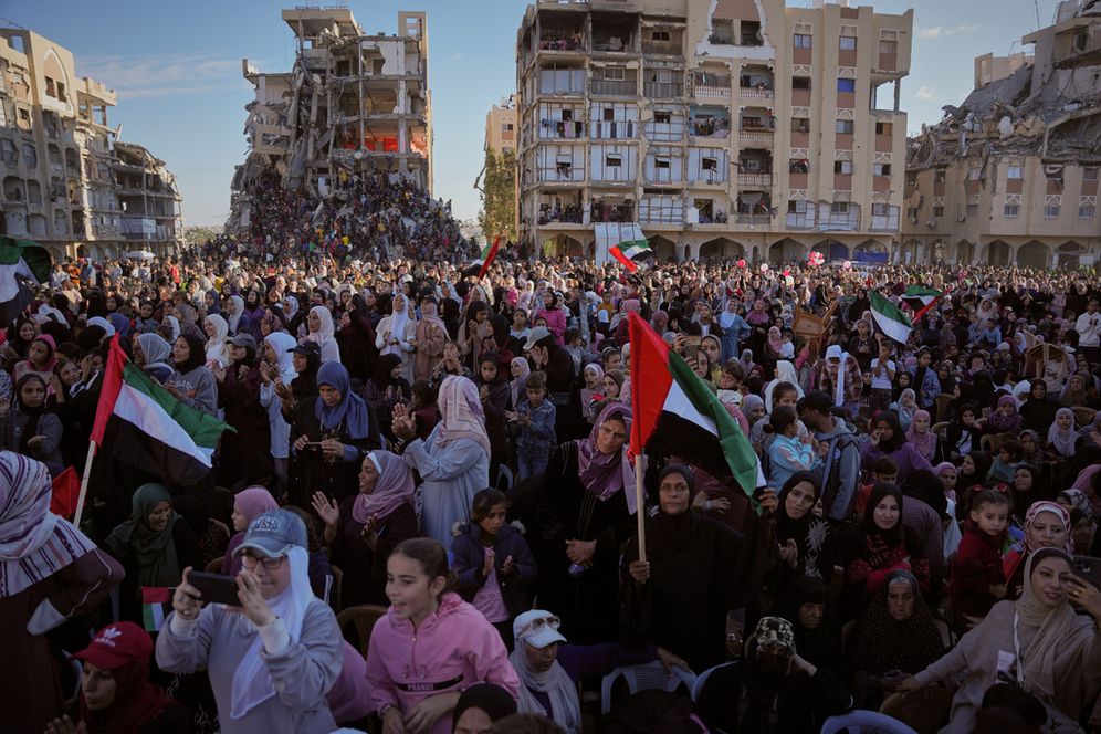 Palestinian watch and celebrate a mass wedding ceremony in Hamad City in Khan Younis, Gaza Strip, Tuesday, Dec. 2, 2025