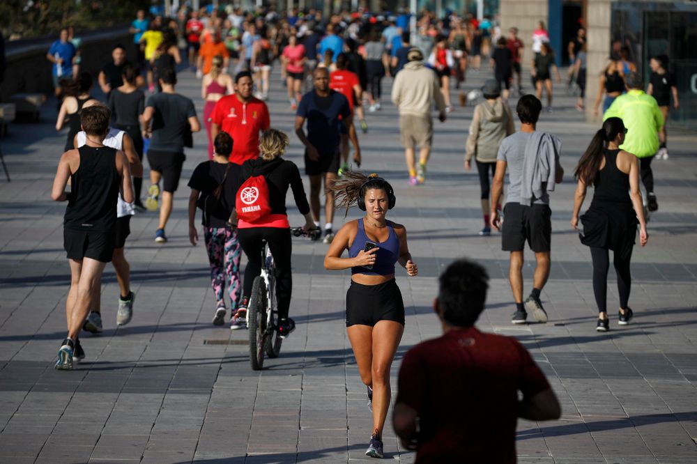 People exercise on a seafront promenade in Barcelona, Spain, May 2, 2020.