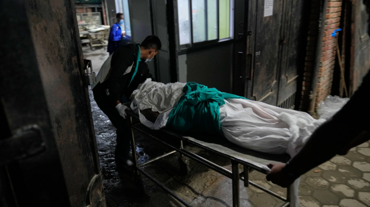Hospital staff transport the body of a flash flood victim from an ambulance to a government hospital mortuary in Kathmandu, Nepal, Aug. 28, 2026

