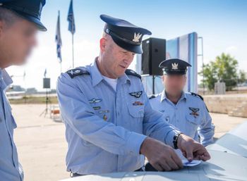 Major General Tomer Bar placing the Israeli Air Force emblem on the "Spark" drone.