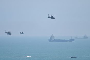Chinese military helicopters fly past Pingtan island, one of mainland China's closest point from Taiwan, in Fujian province on August 4, 2022.