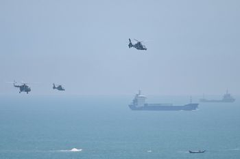 Chinese military helicopters fly past Pingtan island, one of mainland China's closest point from Taiwan, in Fujian province on August 4, 2022.