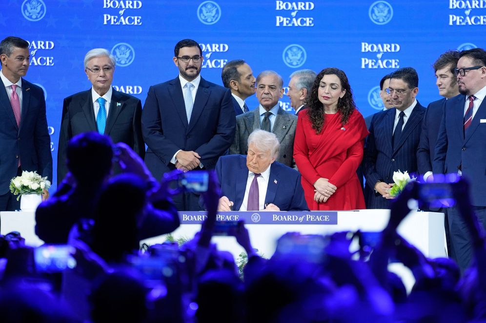 (AP Photo/Markus Schreiber, File) FILE - President Donald Trump signs the charter of his Board of Peace initiative at the Annual Meeting of the World Economic Forum in Davos, Switzerland, Jan. 22, 2026