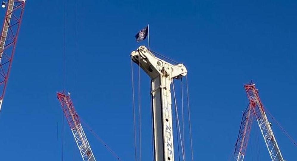A flag representing the Russian mercenary Wagner group on a crane in Tel Aviv, Israel.